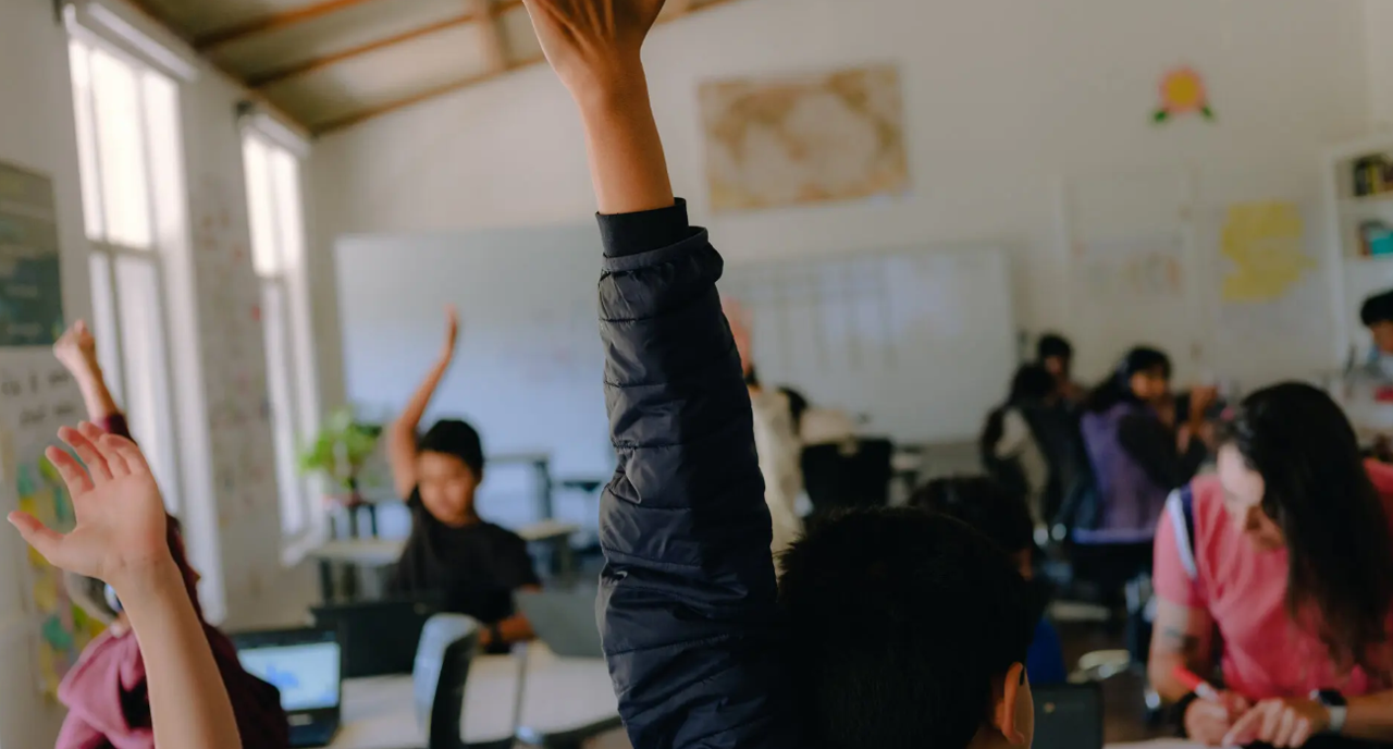 Students raise their hands during a math class at Khan Lab School in Palo Alto, Calif.