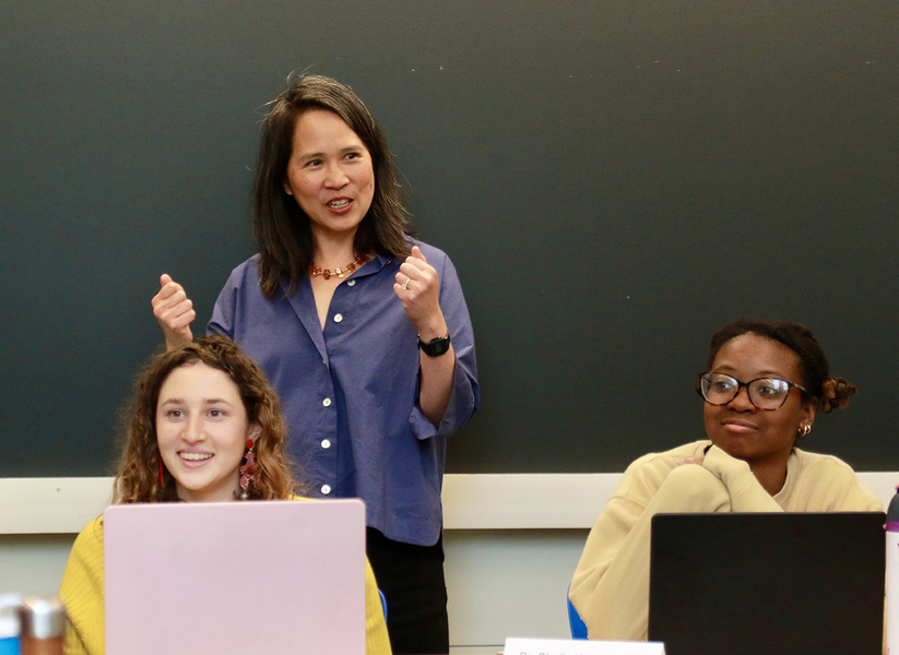 Professor Lily Tsai (standing), in class with teaching assistant Leela Fredlund (left) and student Karenna Caton.